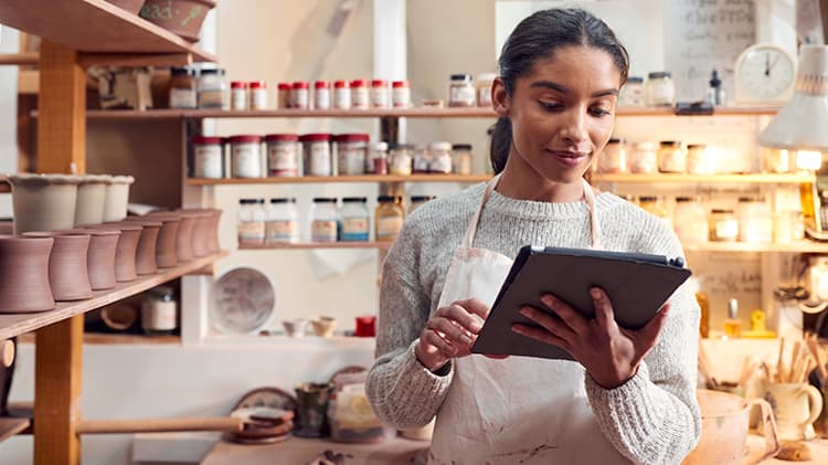 Photo of man and woman tracking shipments for small business